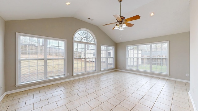 tiled empty room featuring vaulted ceiling and ceiling fan