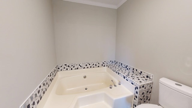 bathroom featuring a bathtub, ornamental molding, and toilet