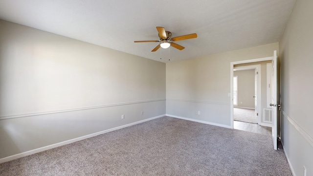 empty room featuring carpet flooring and ceiling fan