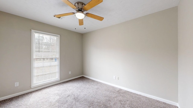 carpeted empty room with a textured ceiling and ceiling fan