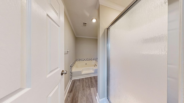 bathroom with crown molding, hardwood / wood-style flooring, a textured ceiling, and separate shower and tub