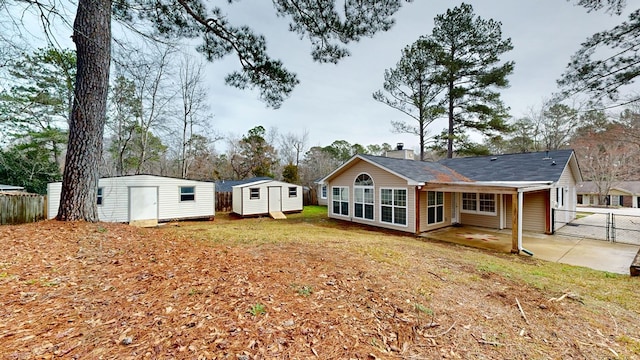 view of front facade with a patio and a storage shed