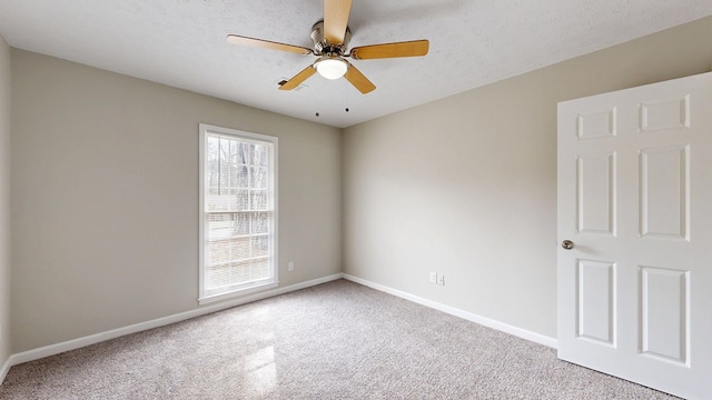 carpeted empty room with a textured ceiling and ceiling fan