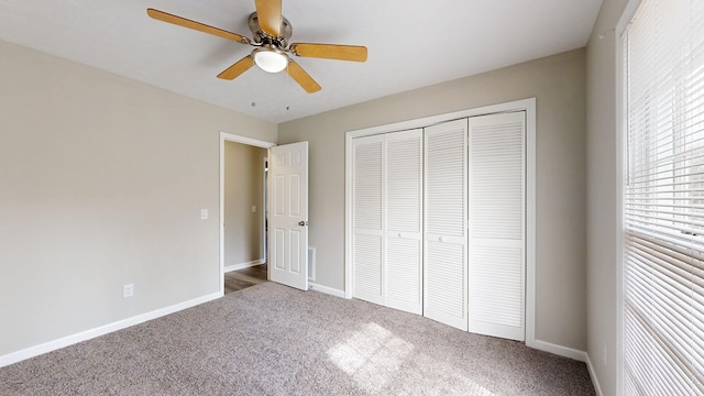 unfurnished bedroom featuring carpet floors, ceiling fan, and a closet