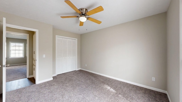 unfurnished bedroom featuring a closet, ceiling fan, and carpet