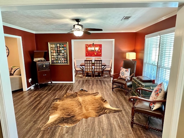 sitting room featuring ceiling fan with notable chandelier, a textured ceiling, wood finished floors, and ornamental molding