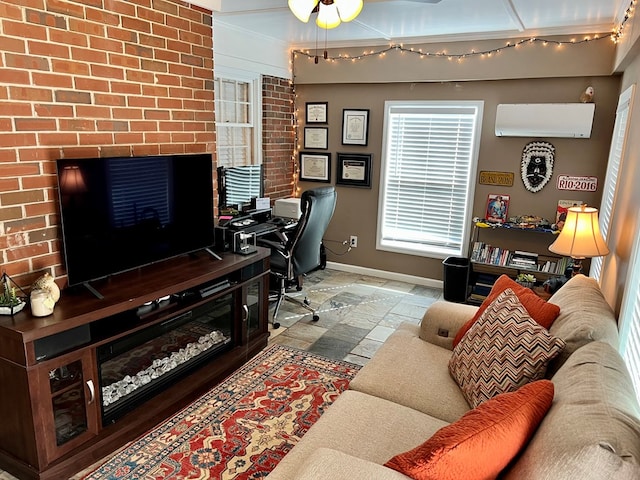 office area with baseboards, stone tile floors, and a wall mounted AC