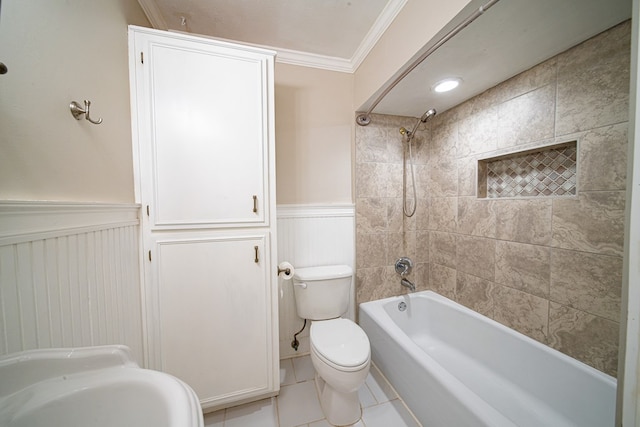 full bathroom with tile patterned floors, a wainscoted wall, toilet,  shower combination, and crown molding