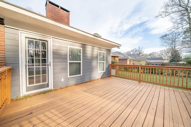 wooden terrace with a yard and fence