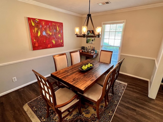 dining area with visible vents, ornamental molding, wood finished floors, baseboards, and a chandelier