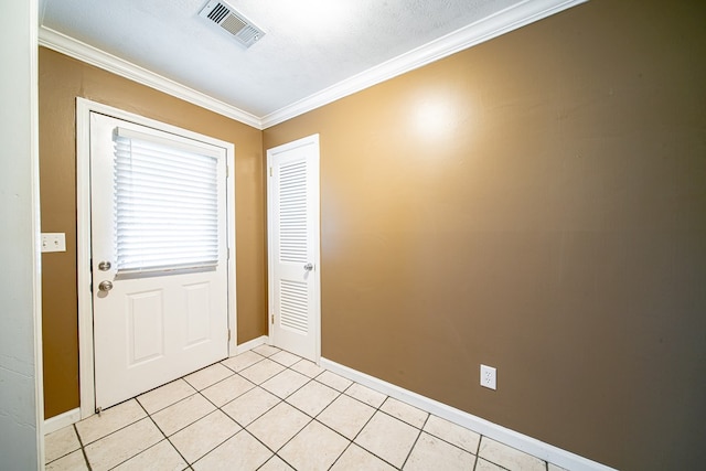 entryway with crown molding, light tile patterned floors, baseboards, and visible vents