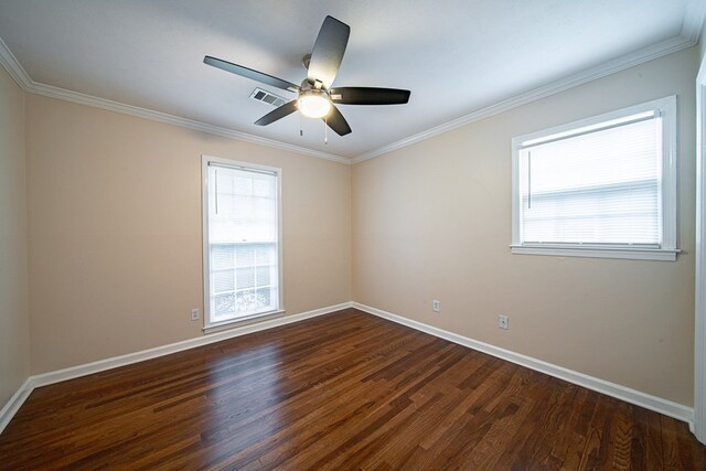 spare room featuring visible vents, plenty of natural light, baseboards, and dark wood-style flooring