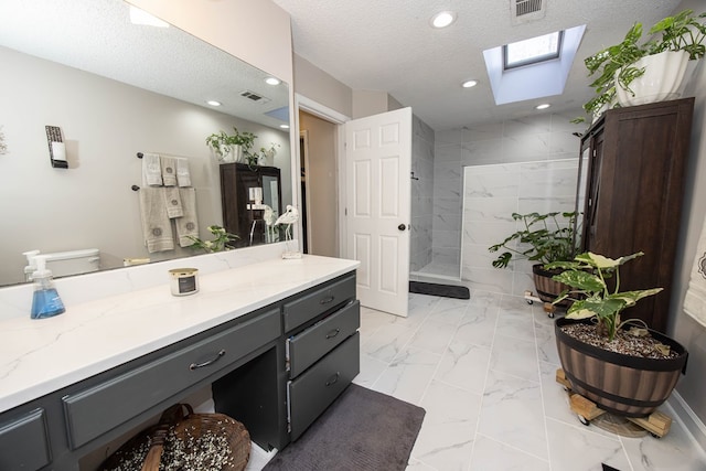 full bath with a walk in shower, marble finish floor, a skylight, and visible vents