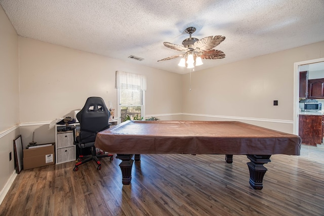 game room featuring a textured ceiling, pool table, wood finished floors, and a ceiling fan