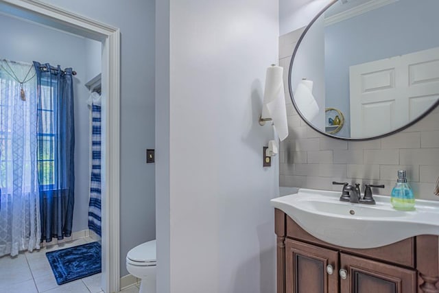 bathroom featuring decorative backsplash, ornamental molding, vanity, tile patterned flooring, and toilet