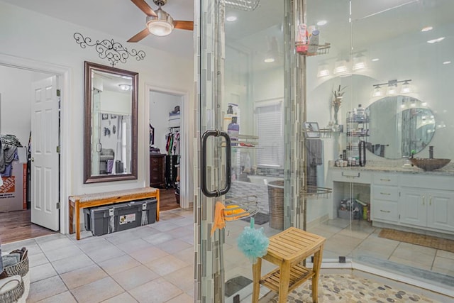 bathroom featuring tile patterned floors, ceiling fan, and vanity