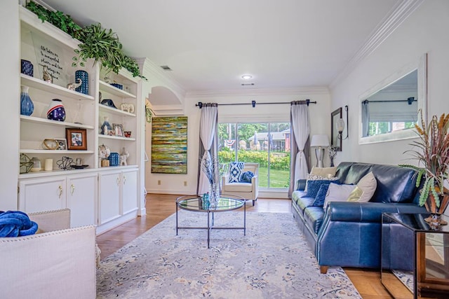 living room with light hardwood / wood-style floors and ornamental molding