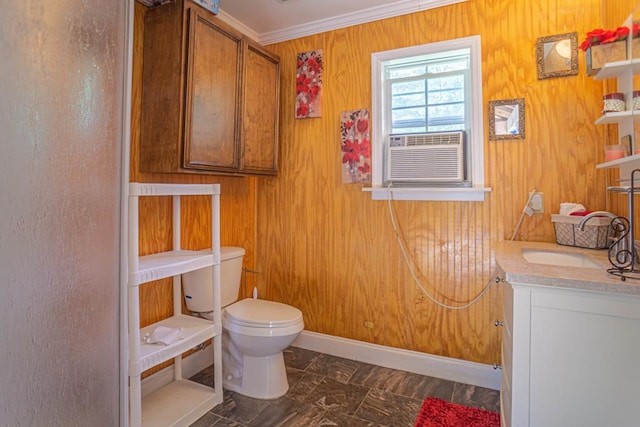 bathroom with crown molding, cooling unit, toilet, wooden walls, and vanity