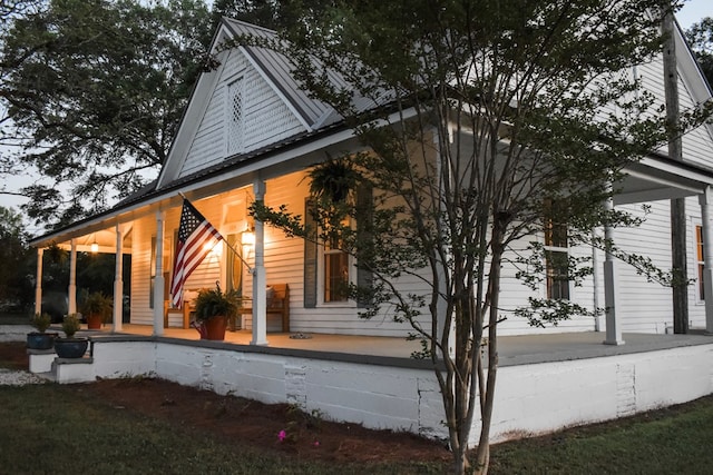 view of side of property with covered porch