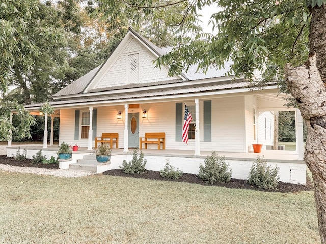 country-style home with a front lawn and covered porch