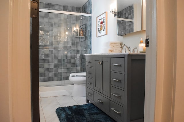 bathroom with an enclosed shower, vanity, toilet, and tile patterned flooring