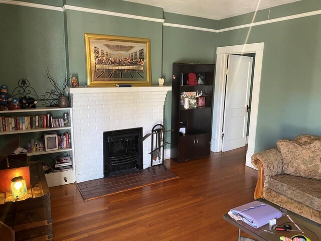 1223 Owsley Ave, Columbus, GA 31906 - living room with wood finished floors and a brick fireplace