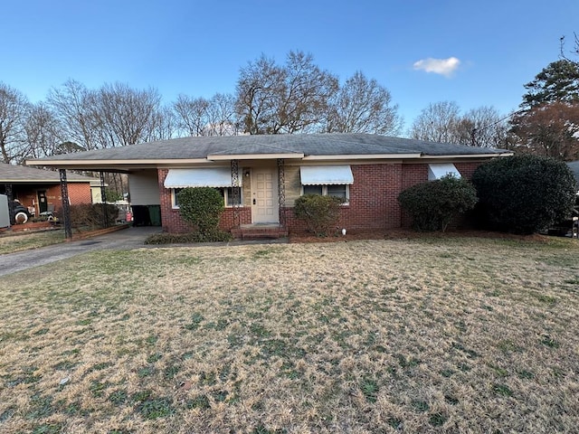 ranch-style house with a carport and a front lawn