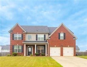 view of front of house featuring a garage and a front yard