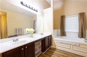 bathroom featuring a tub to relax in, hardwood / wood-style floors, and vanity