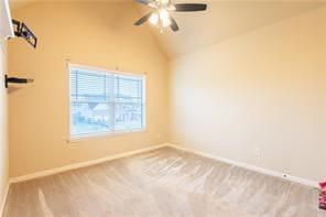 empty room with ceiling fan, carpet floors, and vaulted ceiling