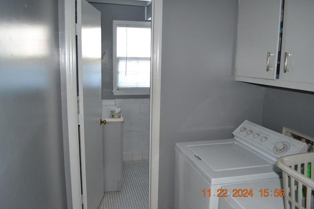 laundry room with tile patterned floors, cabinets, and hookup for a washing machine