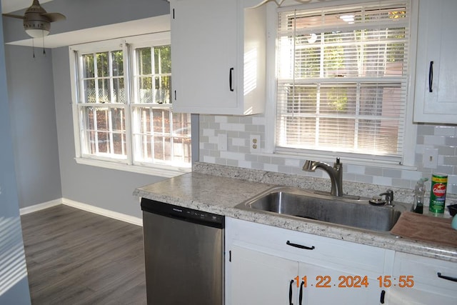 kitchen featuring dishwasher, decorative backsplash, white cabinetry, and sink