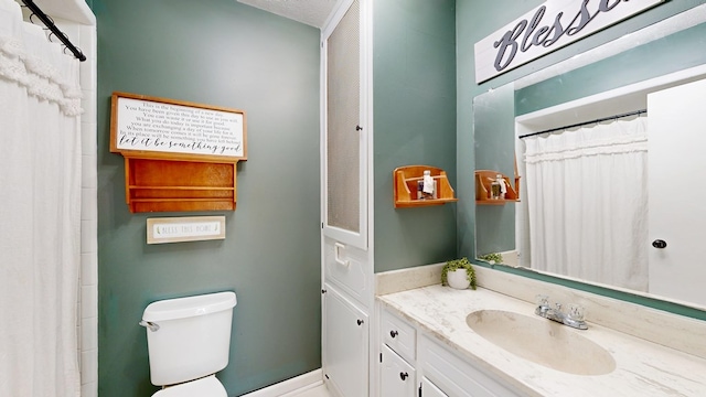 bathroom with toilet and vanity