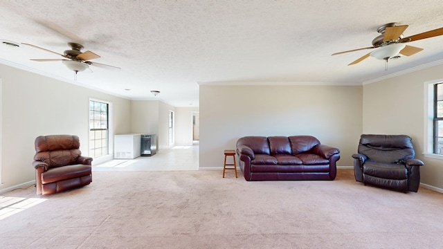 carpeted living room with plenty of natural light, crown molding, and a ceiling fan