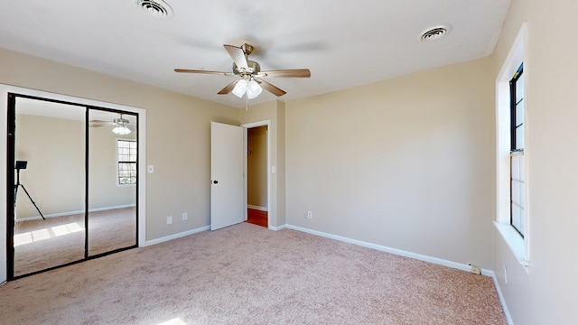 unfurnished bedroom with a closet, baseboards, visible vents, and carpet floors