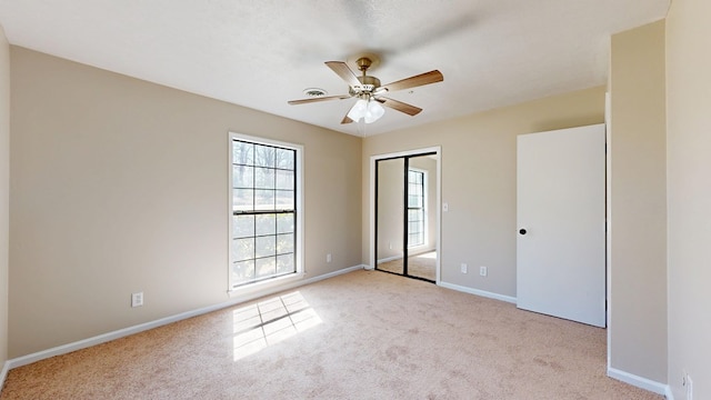 unfurnished bedroom with a closet, carpet flooring, and baseboards