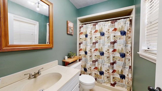 bathroom featuring vanity, toilet, a shower with shower curtain, and a textured ceiling