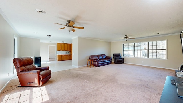 sitting room with light carpet, ornamental molding, visible vents, and ceiling fan