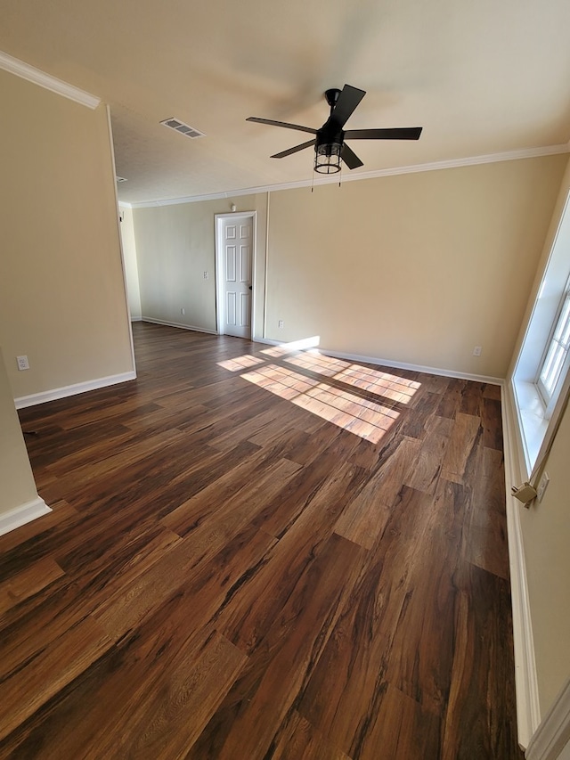 spare room with dark hardwood / wood-style flooring, ceiling fan, and ornamental molding