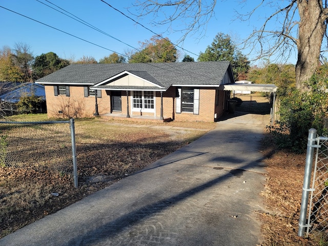 ranch-style home featuring a porch and a carport