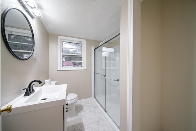 bathroom with toilet, vanity, a stall shower, marble finish floor, and a textured ceiling