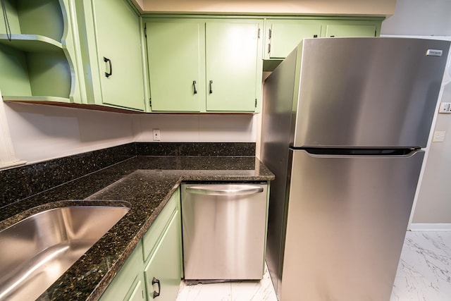 kitchen featuring marble finish floor, a sink, open shelves, stainless steel appliances, and green cabinets