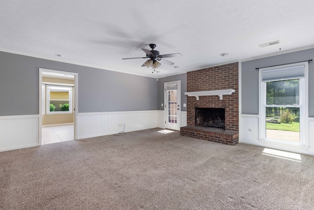 6215 Seaton Dr, Columbus, GA 31909 - unfurnished living room with a wainscoted wall, plenty of natural light, carpet flooring, a ceiling fan, and a fireplace