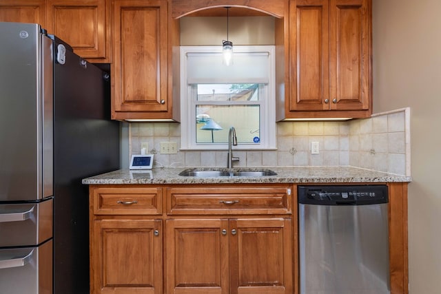 6215 Seaton Dr, Columbus, GA 31909 - kitchen with stainless steel appliances, brown cabinets, backsplash, and light stone countertops