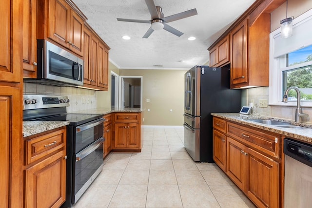 6215 Seaton Dr, Columbus, GA 31909 - kitchen featuring stainless steel appliances, decorative backsplash, brown cabinetry, light stone counters, and ceiling fan