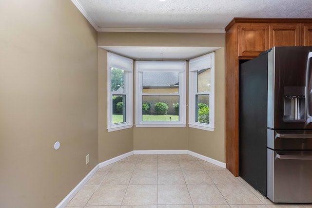 6215 Seaton Dr, Columbus, GA 31909 - kitchen with stainless steel fridge with ice dispenser, ornamental molding, light tile patterned flooring, and brown cabinets