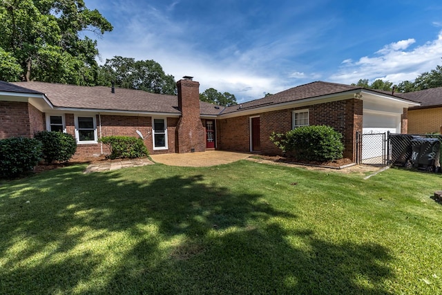 6215 Seaton Dr, Columbus, GA 31909 - back of property with a garage, a chimney, brick siding, and roof with shingles