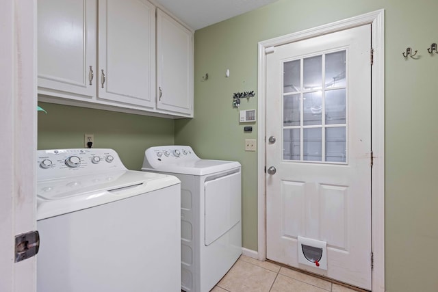 6215 Seaton Dr, Columbus, GA 31909 - laundry area featuring independent washer and dryer, cabinet space, and light tile patterned flooring