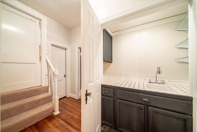 interior space with hardwood / wood-style flooring, vanity, and a textured ceiling