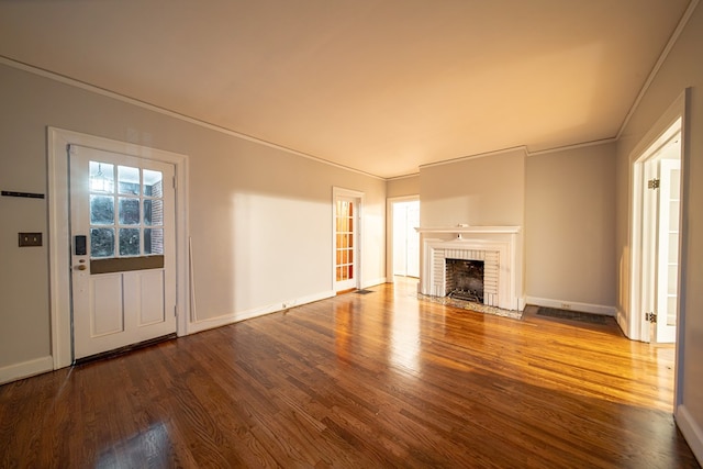 unfurnished living room with a fireplace, wood-type flooring, and ornamental molding